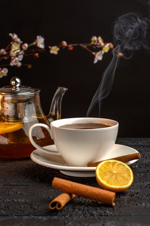 cup-tea-with-lemon-cinnamon-kettle-grey-surface